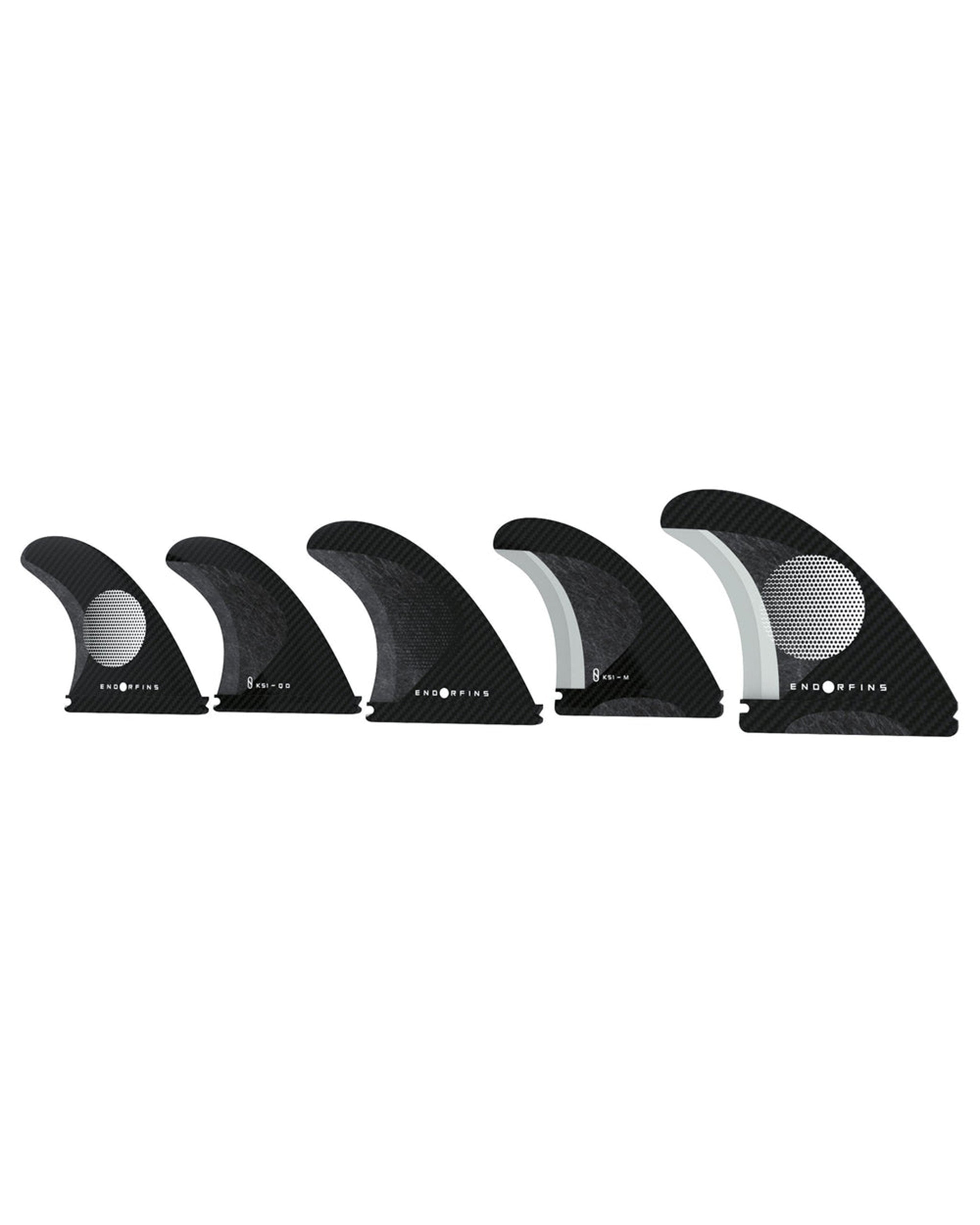 Set of six black surfboard fins with white center on a white background