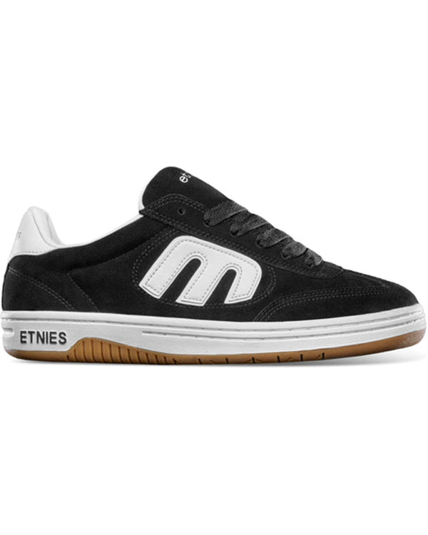 Side view of black Etnies skate shoe with white logo and gum sole.