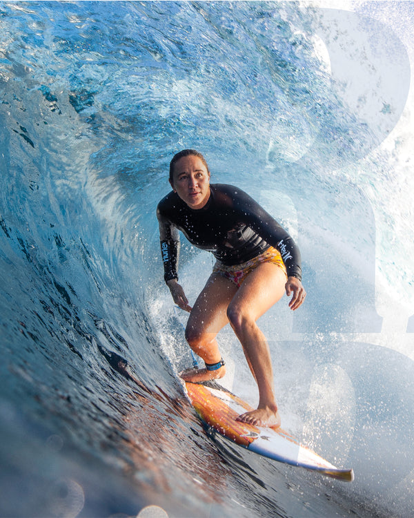 Surfer riding inside a wave barrel on a shortboard with Carissa Moore FCS fins installed