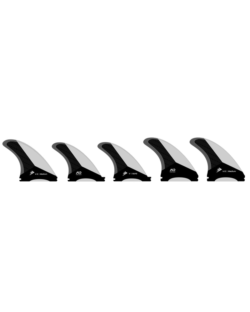 Set of five black and white surfboard fins on a white background