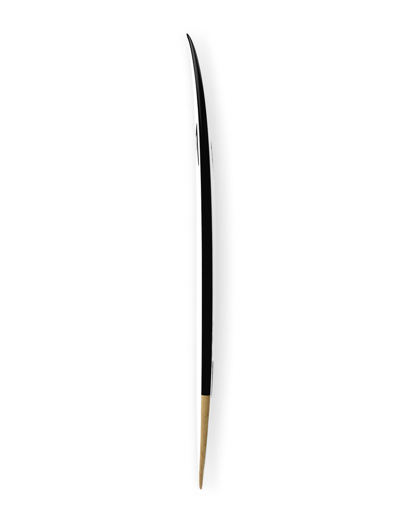 Side view of the board showing subtle rocker and sharp tail taper in black and natural tones.