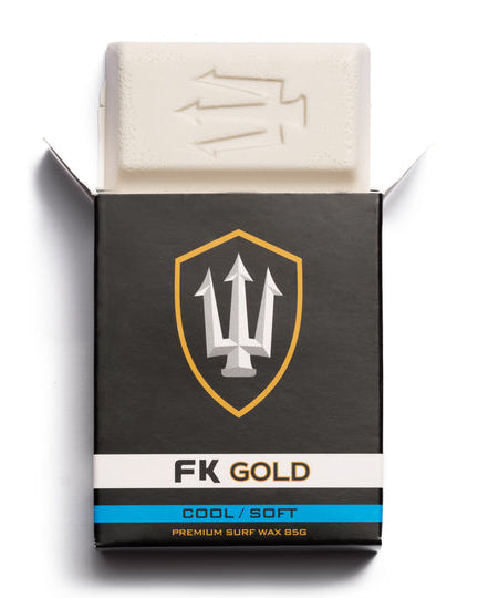 Opened FK Gold Cool Soft surf wax box showing white wax block with embossed trident logo for easy grip.