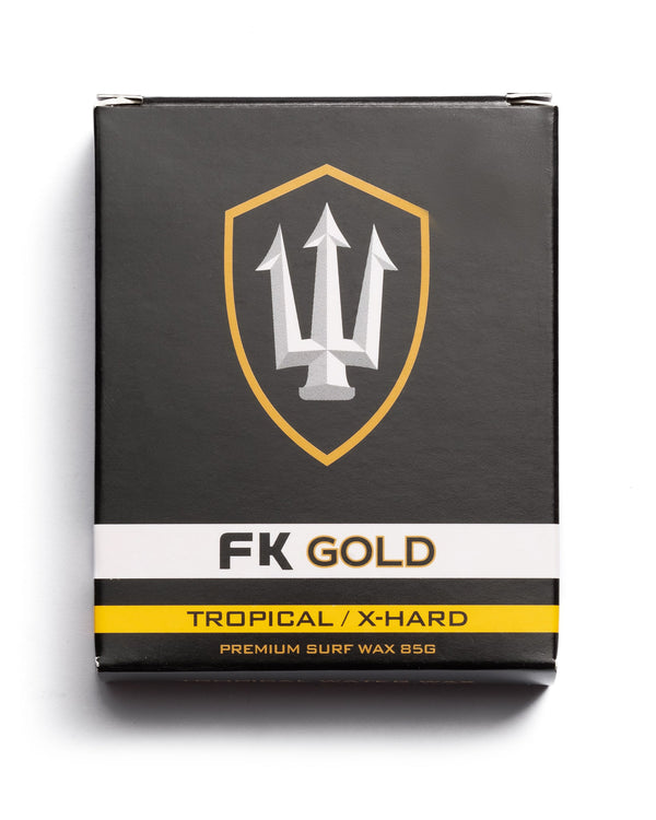FK Gold Tropical X-Hard surf wax 85g in black and yellow packaging for warm water performance and grip.