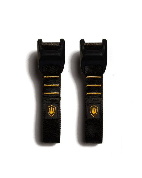 Black tie-down straps with black buckles and yellow stitching, featuring a yellow trident logo on each strap.
