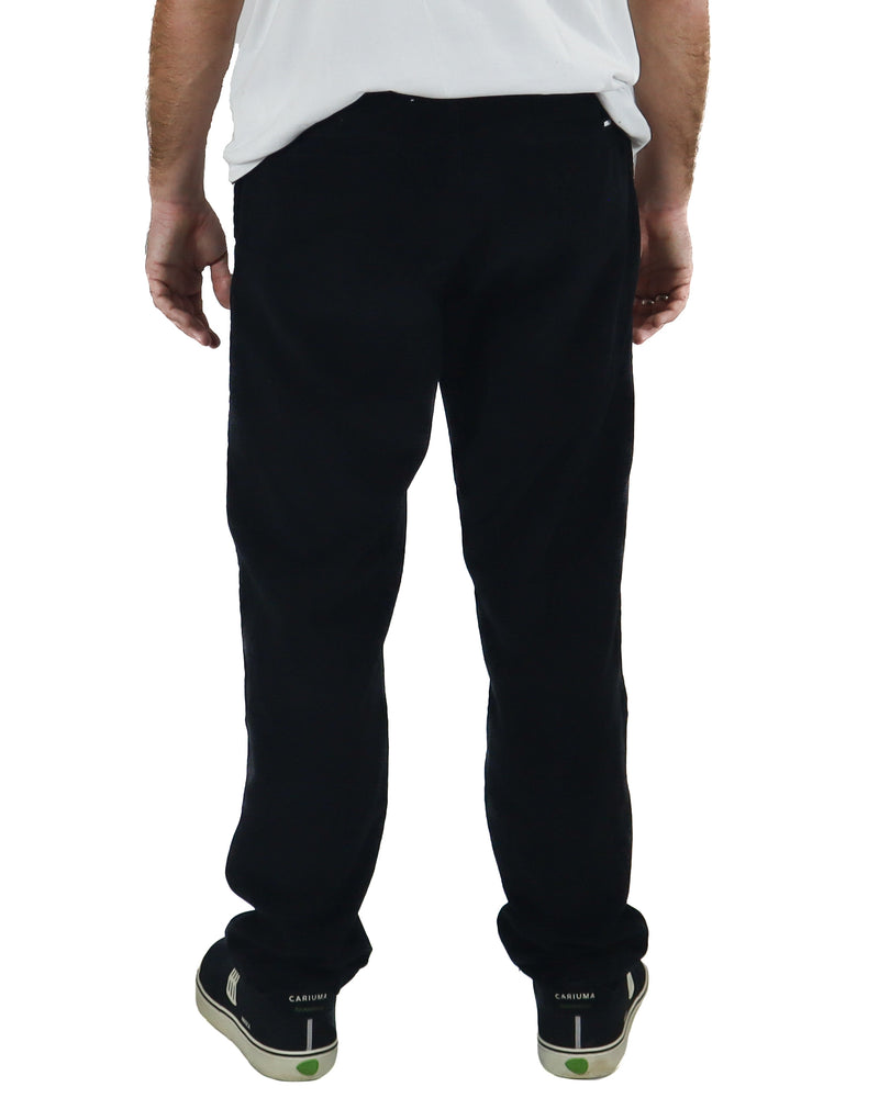 Rear view of black corduroy pants with a mid-rise waist and loose fit