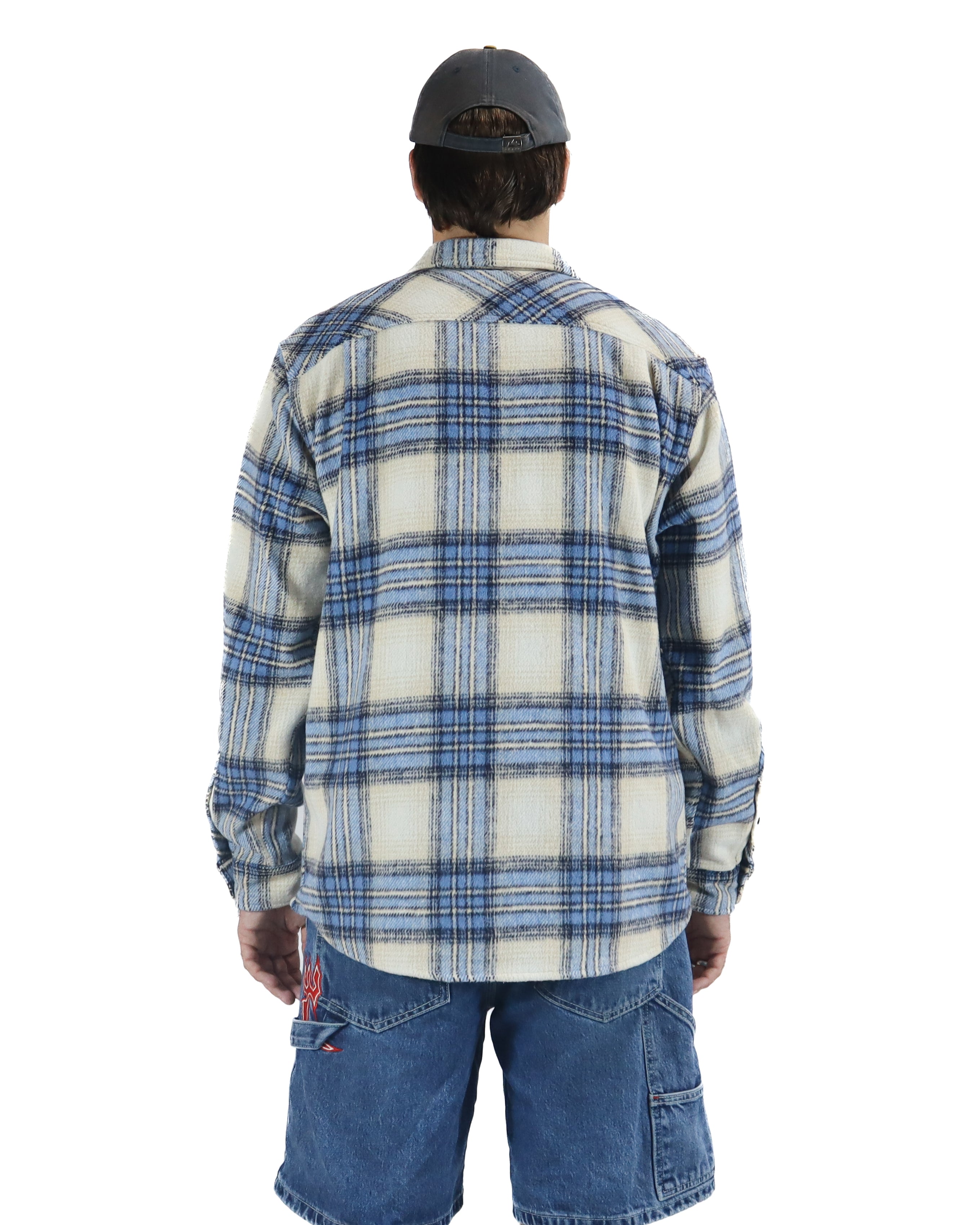 Back view of cream and blue plaid flannel shirt with curved hem