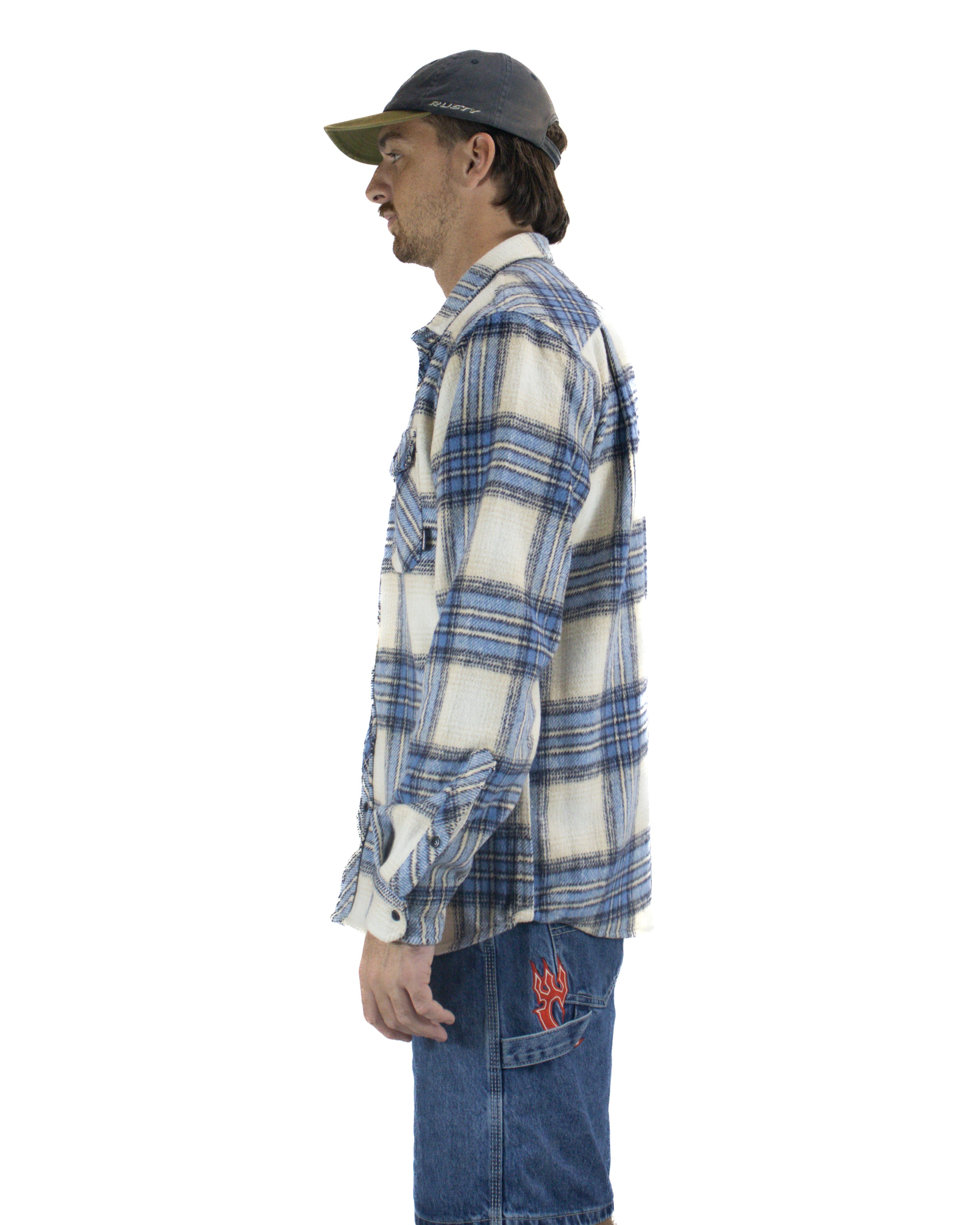 Side profile of relaxed fit flannel shirt with long sleeves and check pattern