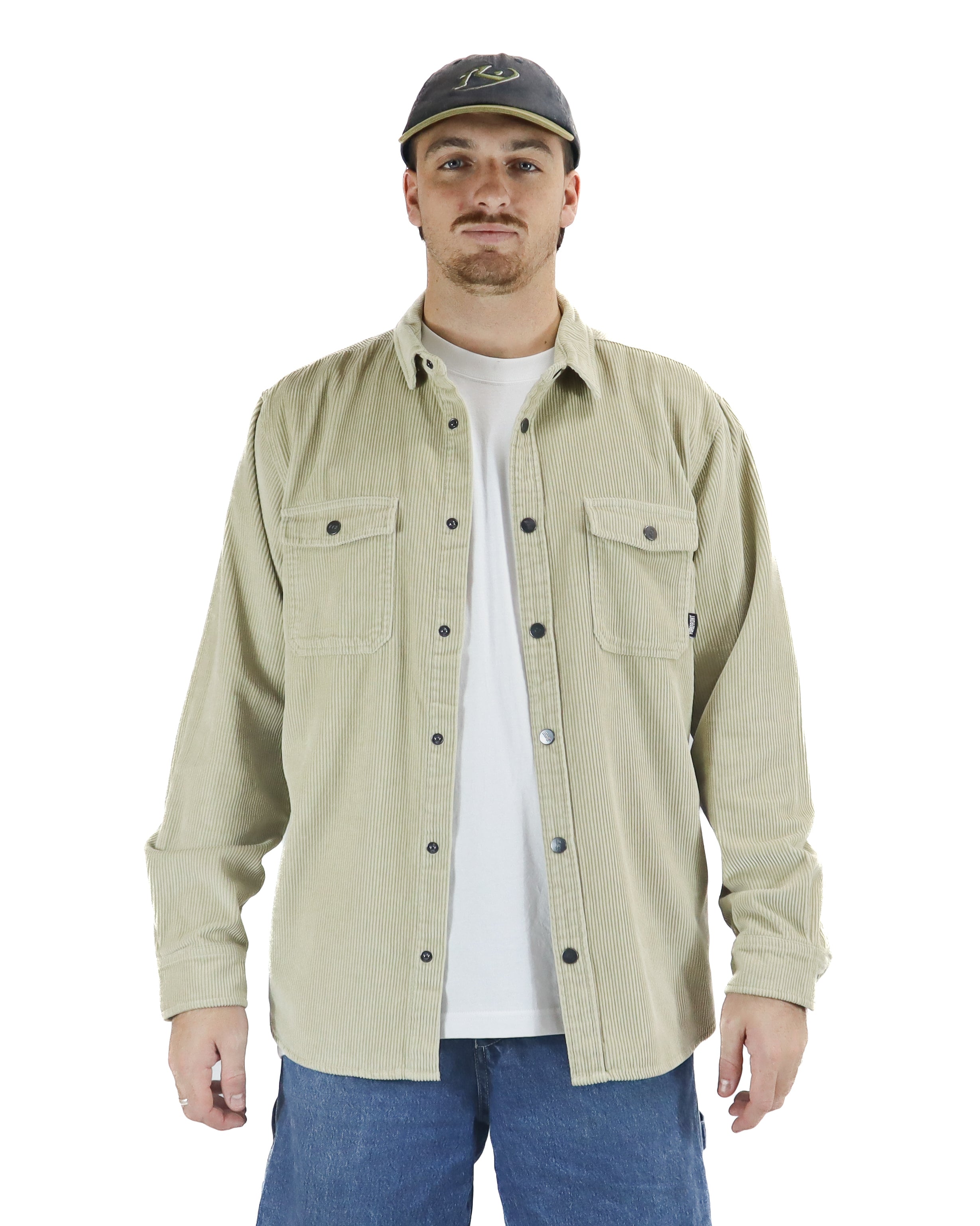 Beige corduroy button-up shirt with chest pockets, worn open over white tee