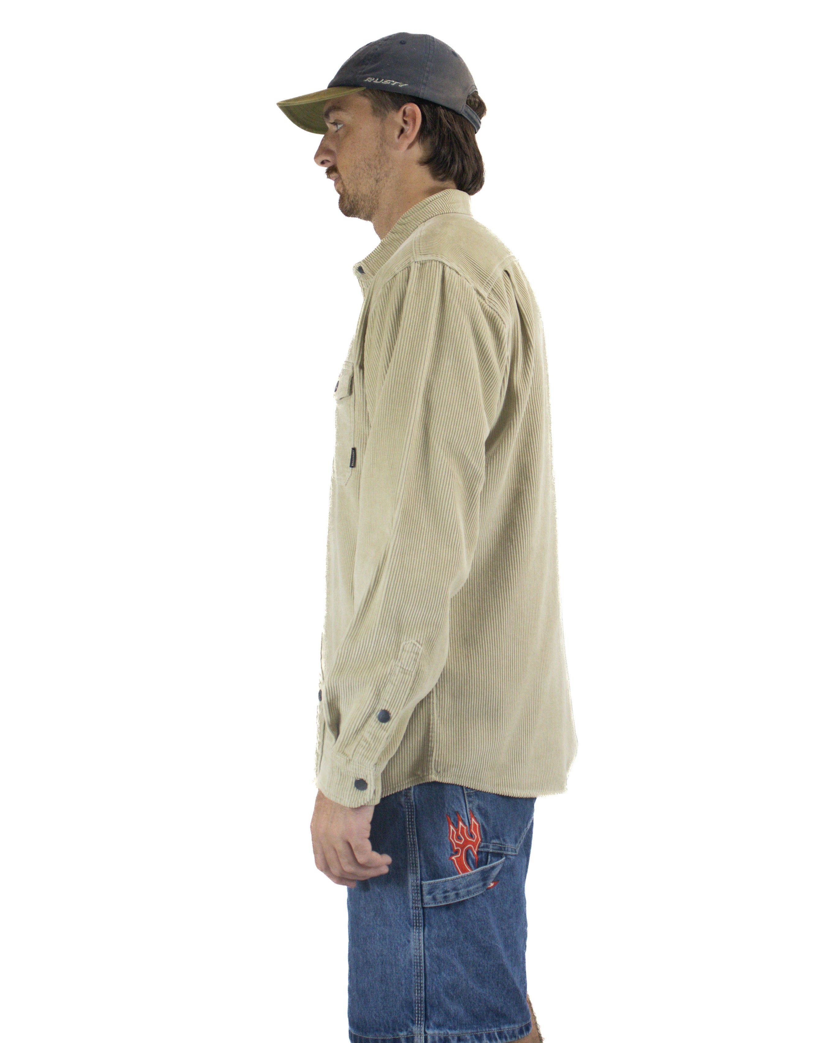 Side view of beige cord shirt with buttoned cuffs and relaxed fit