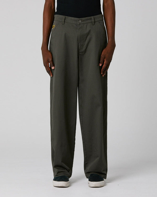 Dark olive wide-leg pants with belt loops and side pockets, worn with casual sneakers