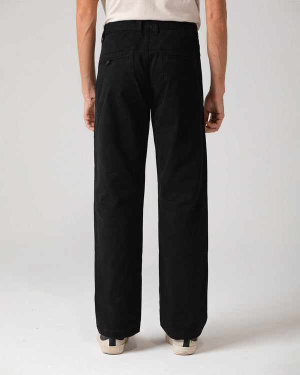 Black pants rear view highlighting tailored back pockets and relaxed fit.