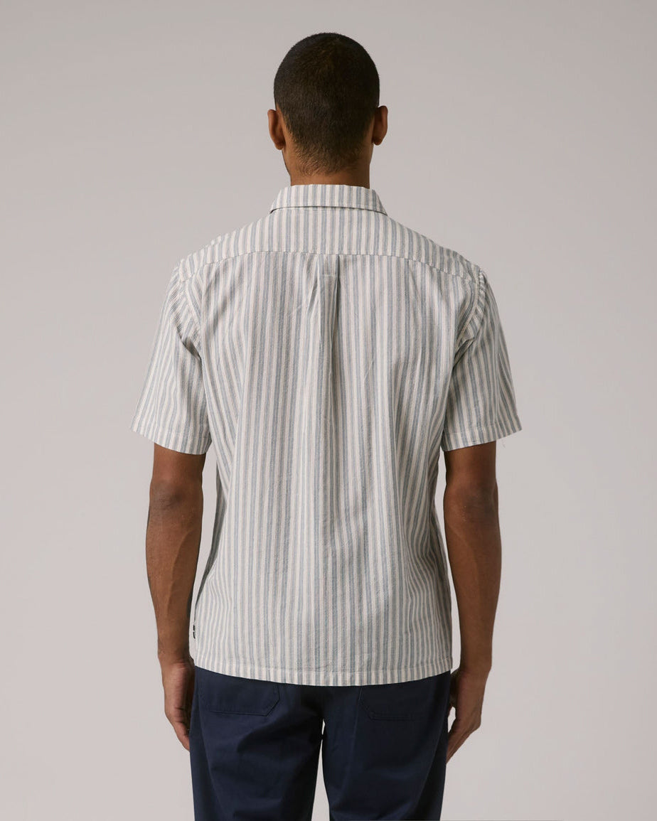 Back view of striped men's button-up shirt with relaxed fit and straight hem