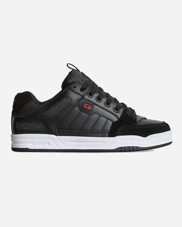 Black and white low-top skate shoe with padded collar, perforated details, and red logo accents on the side and tongue.