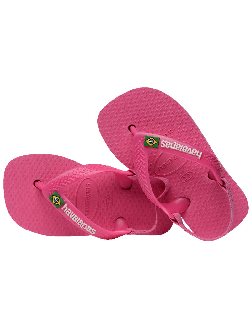 Pair of pink Havaianas baby sandals stacked on an angle, showing back straps and textured soles.