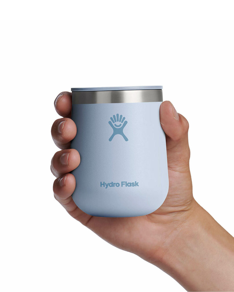 Hand holding a light blue Hydro Flask tumbler, perfect for wine, coffee, or chilled beverages on the go.