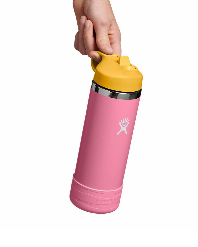Hand holding a pink Hydro Flask with yellow lid, featuring a carry loop and flip straw for easy sipping.