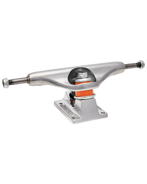 Silver skateboard truck with a polished finish, visible orange bushings, durable baseplate, and axles, side angle view.