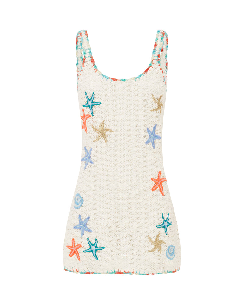 White crochet mini dress with colorful embroidered starfish and seashell details, featuring a scoop neckline and thick straps.