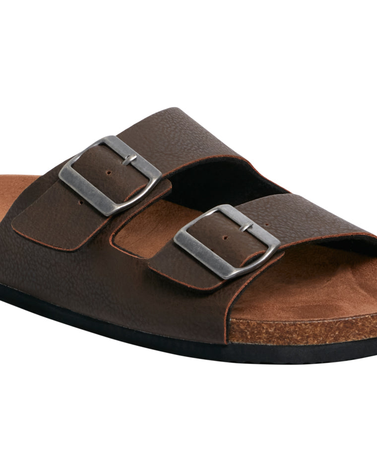 Close-up angled view of the front half of a brown sandal, highlighting the textured straps, silver buckles, and cork-look midsole.