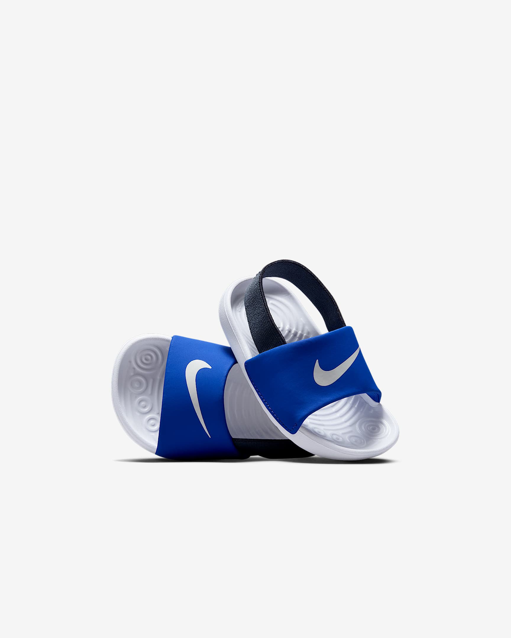 Nike kids' slides in blue with white Swoosh and elastic heel strap, stacked with sole detailing.