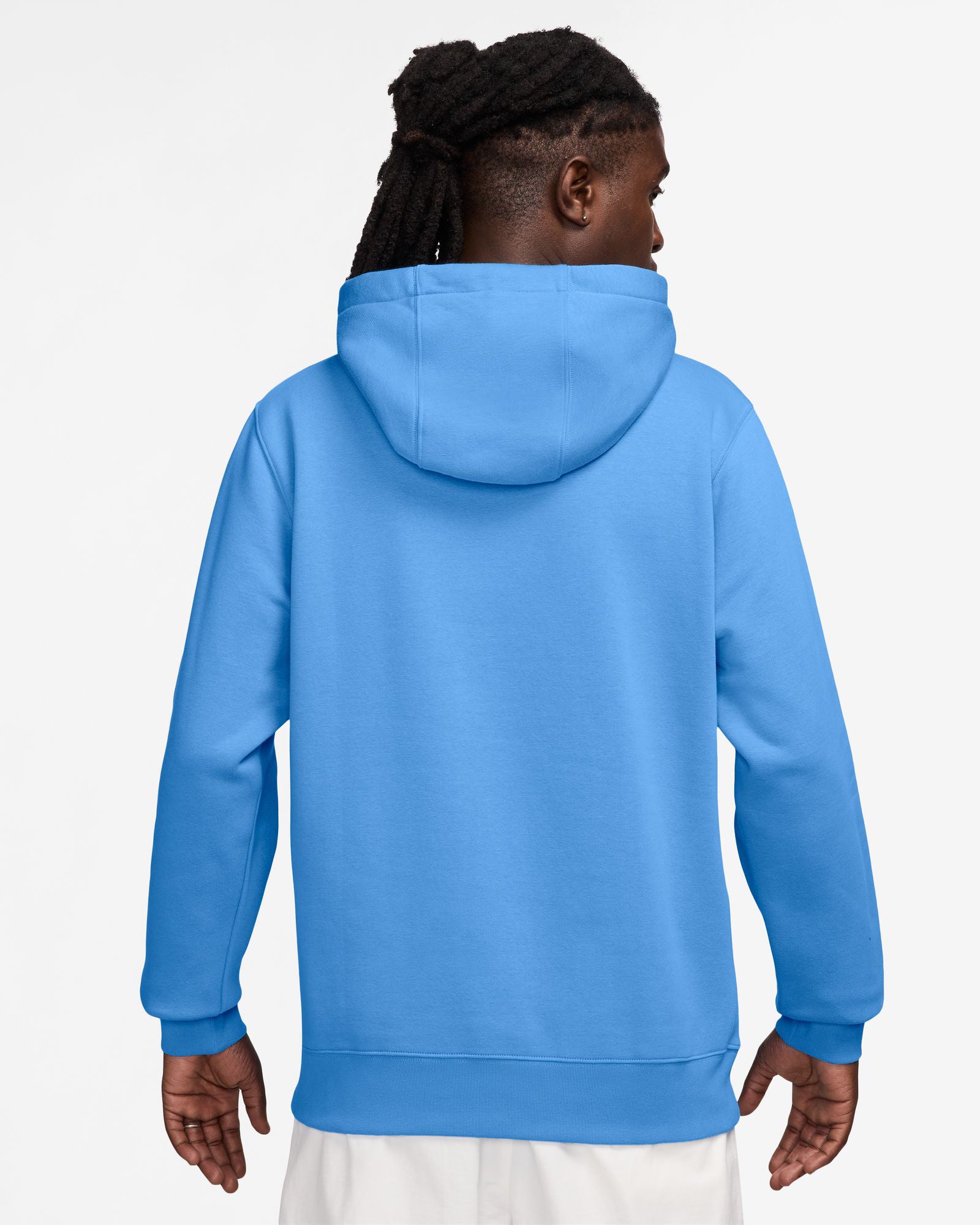 Back view of a model wearing a bright blue Nike hoodie with a relaxed fit, ribbed cuffs, and a spacious hood.