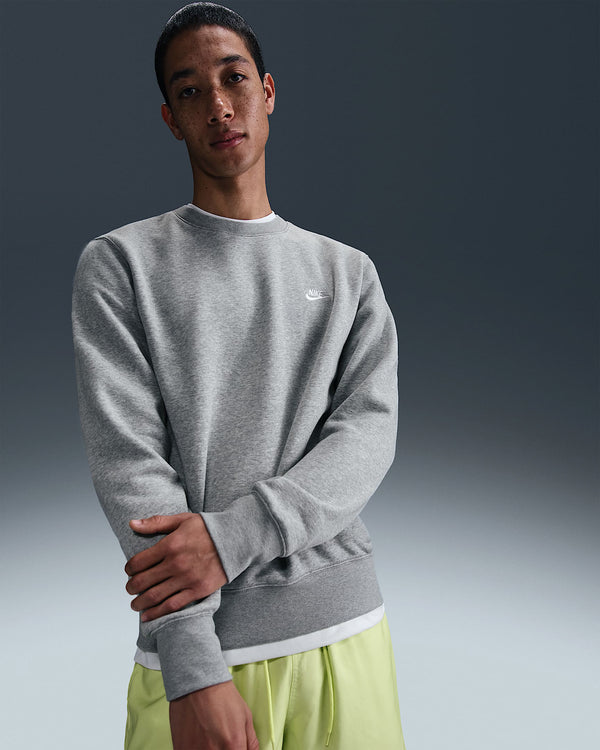 Nike grey crew neck fleece sweatshirt styled with neon yellow shorts and white sneakers