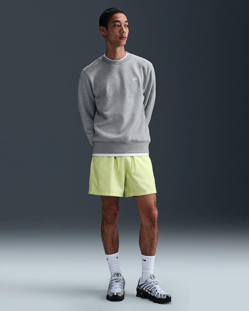 Full-body view of Nike grey sweatshirt and neon shorts with athletic sneakers