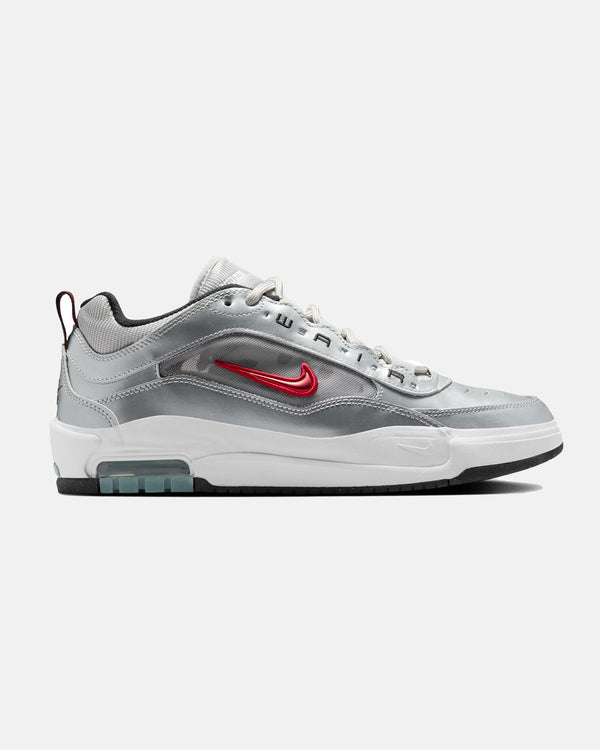 Side view of a silver Nike Air Max sneaker with a red swoosh, white midsole, and black outsole featuring a visible air unit.