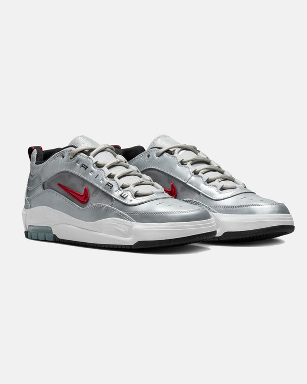 Pair of silver Nike Air Max sneakers with red swooshes, white midsoles, and black outsoles, featuring a futuristic design.