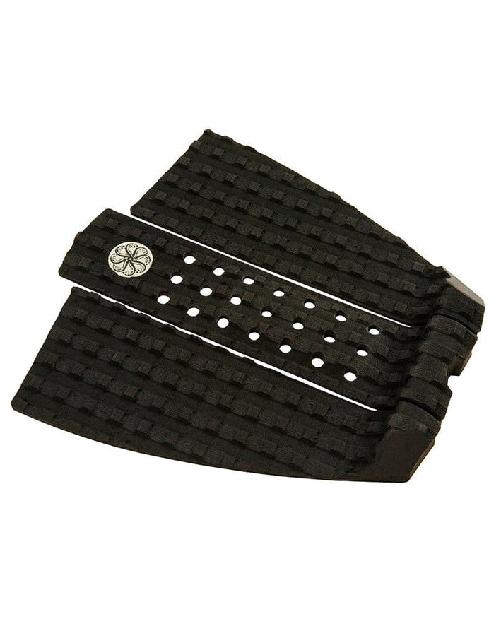 Angled view of black tail pad with arch support, square grooves and circular grip holes