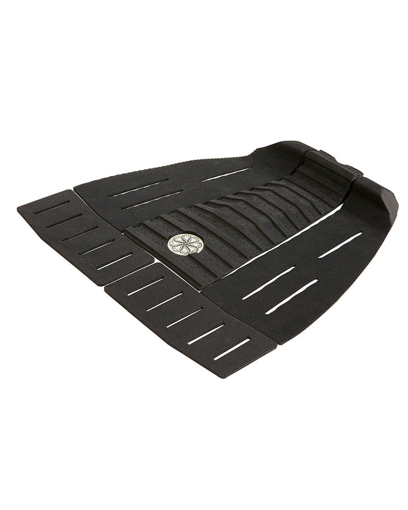 Angled view of black surfboard tail pad showing arch support and multi-panel layout