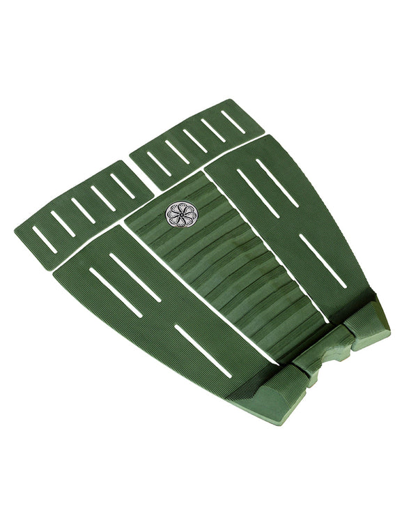 Angled view of green traction pad showing textured grooves and raised tail kick.