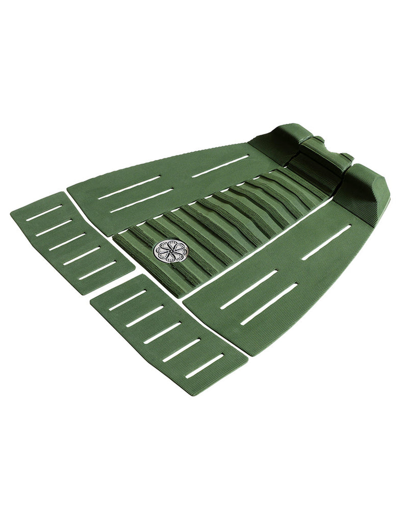 Side perspective of five-piece green grip pad with arch support and ribbed channels.