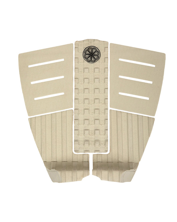 Beige 3-piece surfboard tail pad with arch bar, horizontal slits and circular black traction logo
