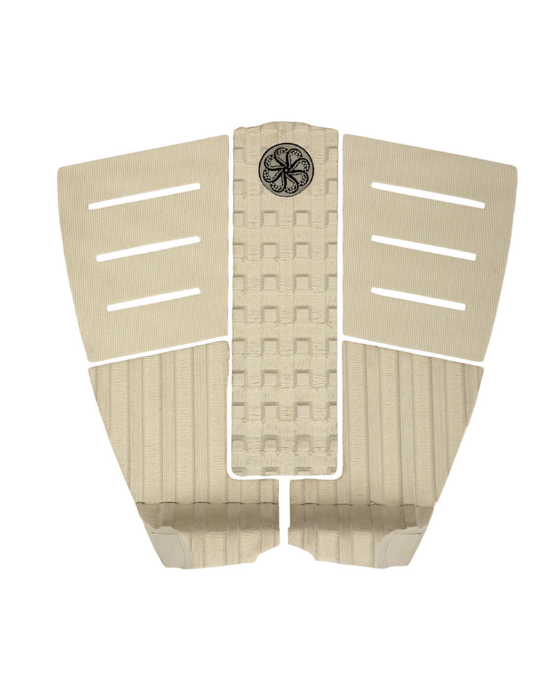 Beige 3-piece surfboard tail pad with arch bar, horizontal slits and circular black traction logo