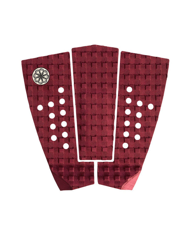 Burgundy three-piece surfboard traction pad with circular holes and woven texture.
