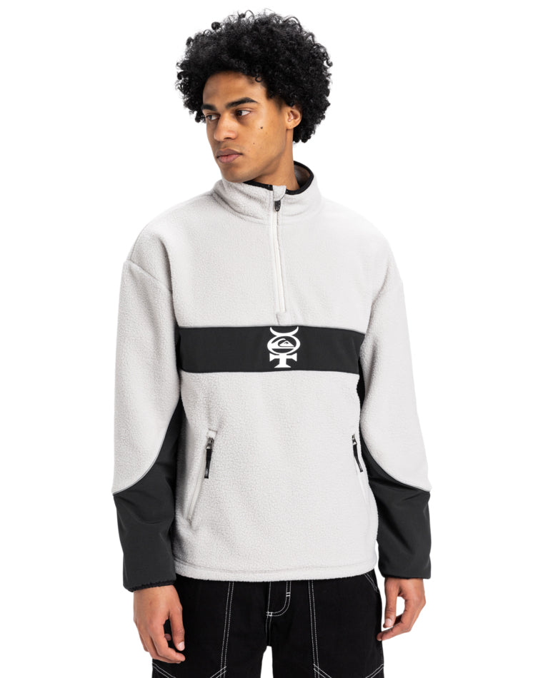 Men's light grey and black Quiksilver fleece pullover with a quarter-zip, contrast panel, and logo at chest.