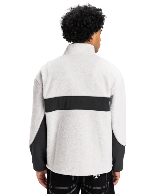 Back view of men's light grey and black Quiksilver fleece pullover with contrast panel and high collar.