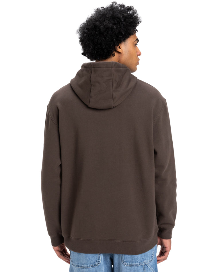Back view of a man wearing a brown Quiksilver hoodie with a relaxed fit, featuring a hood and ribbed cuffs, paired with jeans.