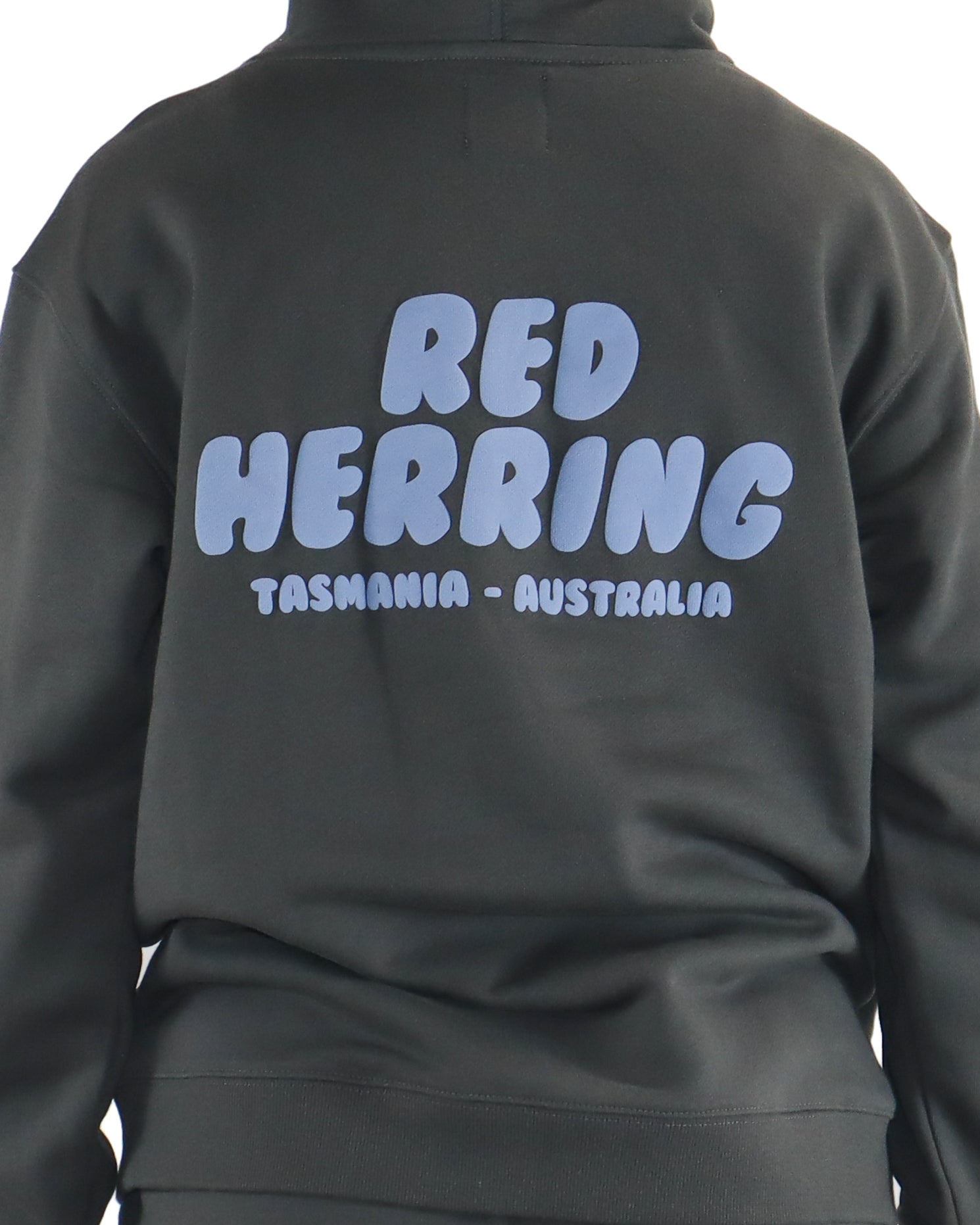 Close-up of large blue Red Herring Tasmania Australia text on hoodie back