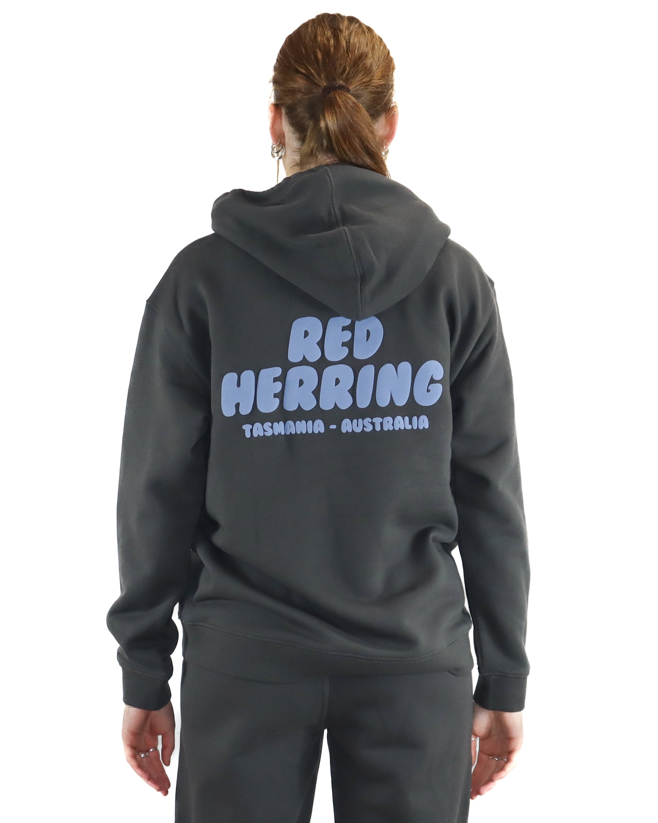 Back view of black hoodie with bold blue Red Herring Tasmania Australia graphic