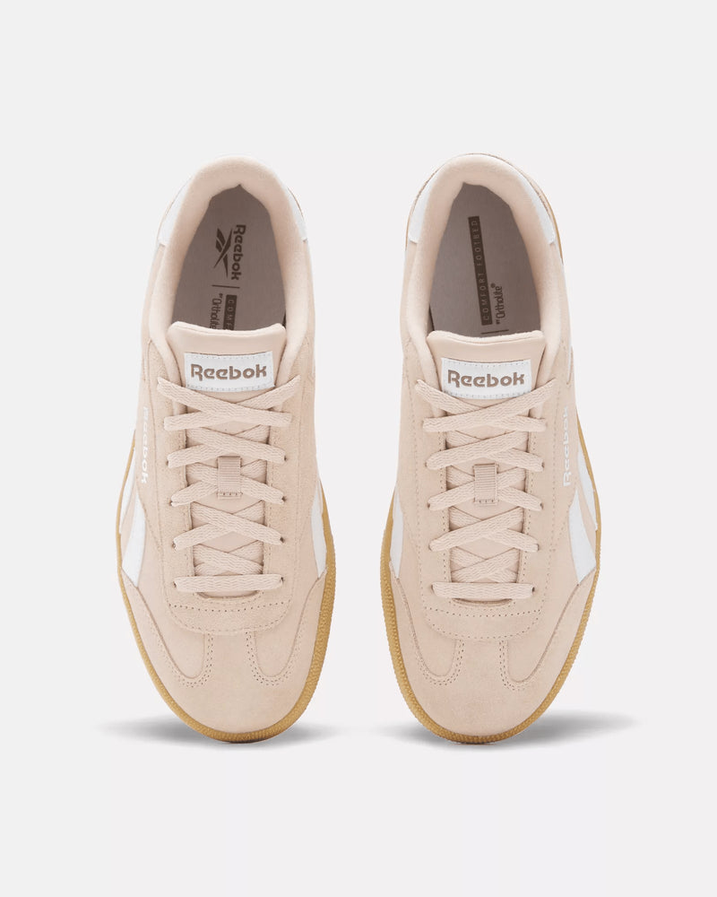 Top-down view of pink Reebok sneakers with white accents, gum outsole, lace-up closure, and classic branding on the tongue.