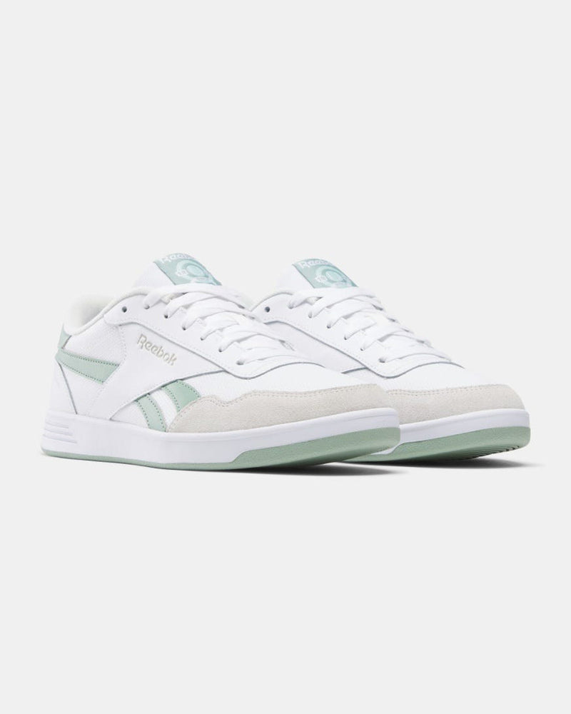 Pair of white Reebok sneakers with pastel green accents, showcasing a sleek low-cut design and clean finish.