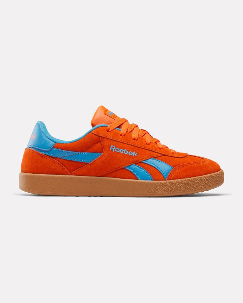 A side view of bright orange low-top Reebok sneakers with blue accents, orange laces, and a gum rubber sole.