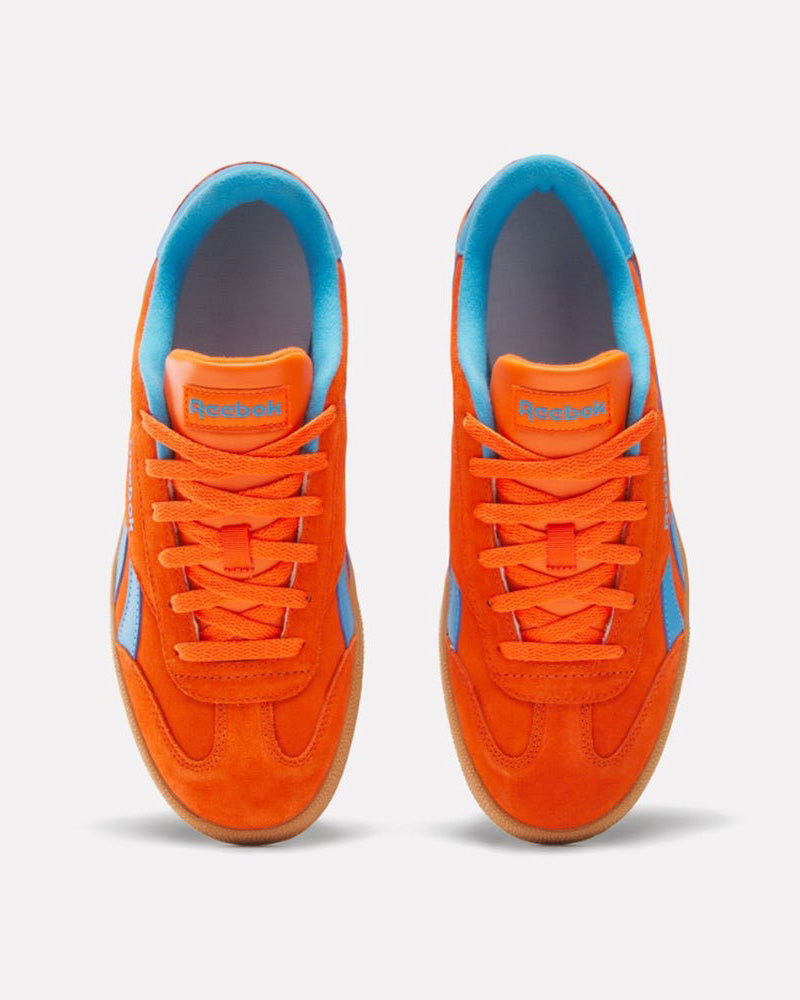 Top view of orange Reebok sneakers featuring blue accents, orange laces, and light blue interior lining with gum rubber soles.