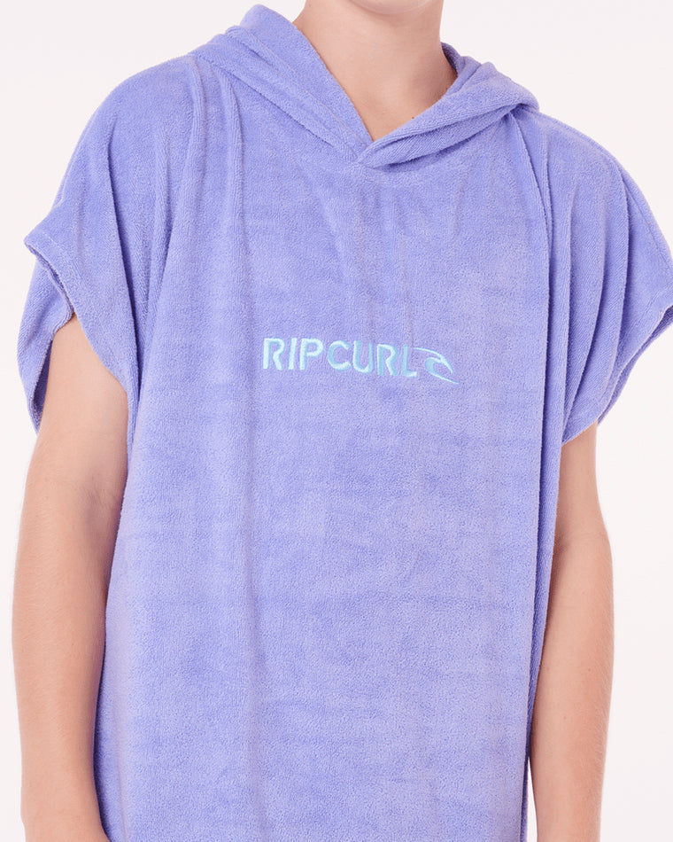 Close-up of Rip Curl logo on purple hooded towel.