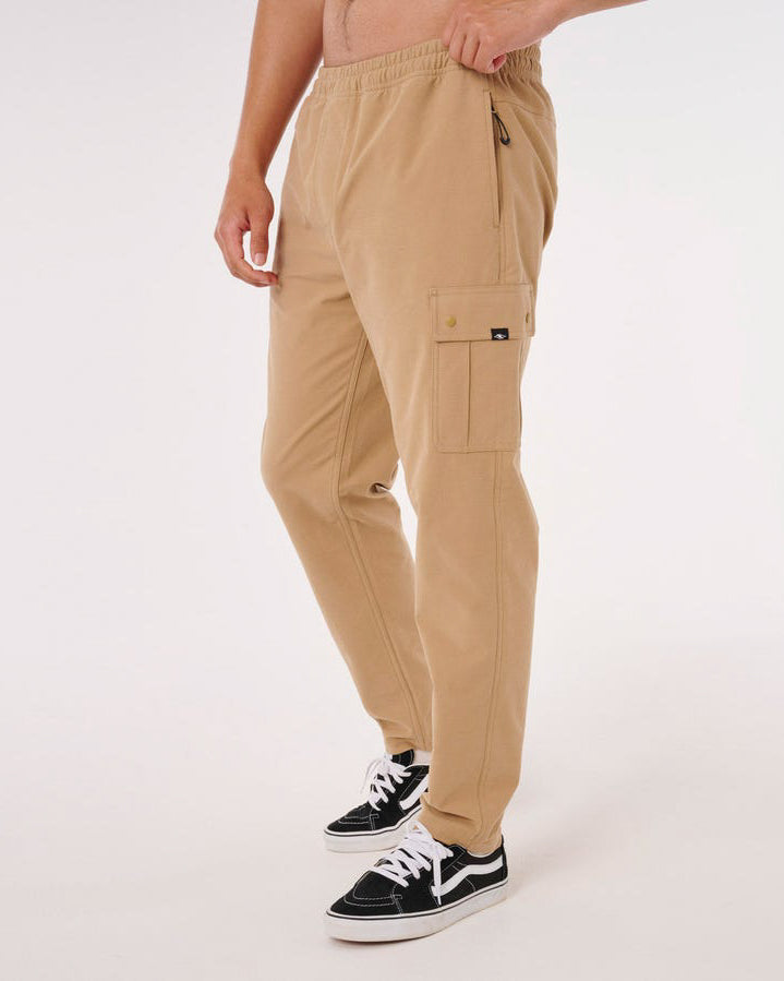 Side view of men's tan cargo pants with flap pocket and elastic waist.