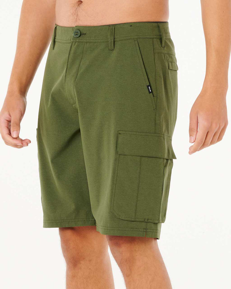 Side angle of olive green cargo shorts featuring side zip and flap pockets with clean stitching.