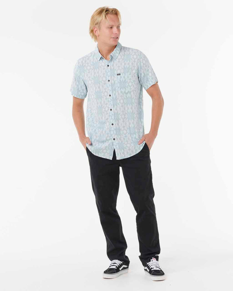 Full outfit with light blue patterned shirt and black pants.