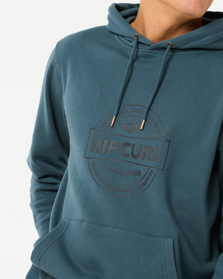 Close-up of a teal Rip Curl hoodie featuring a front logo design, drawstring hood, and kangaroo pocket.